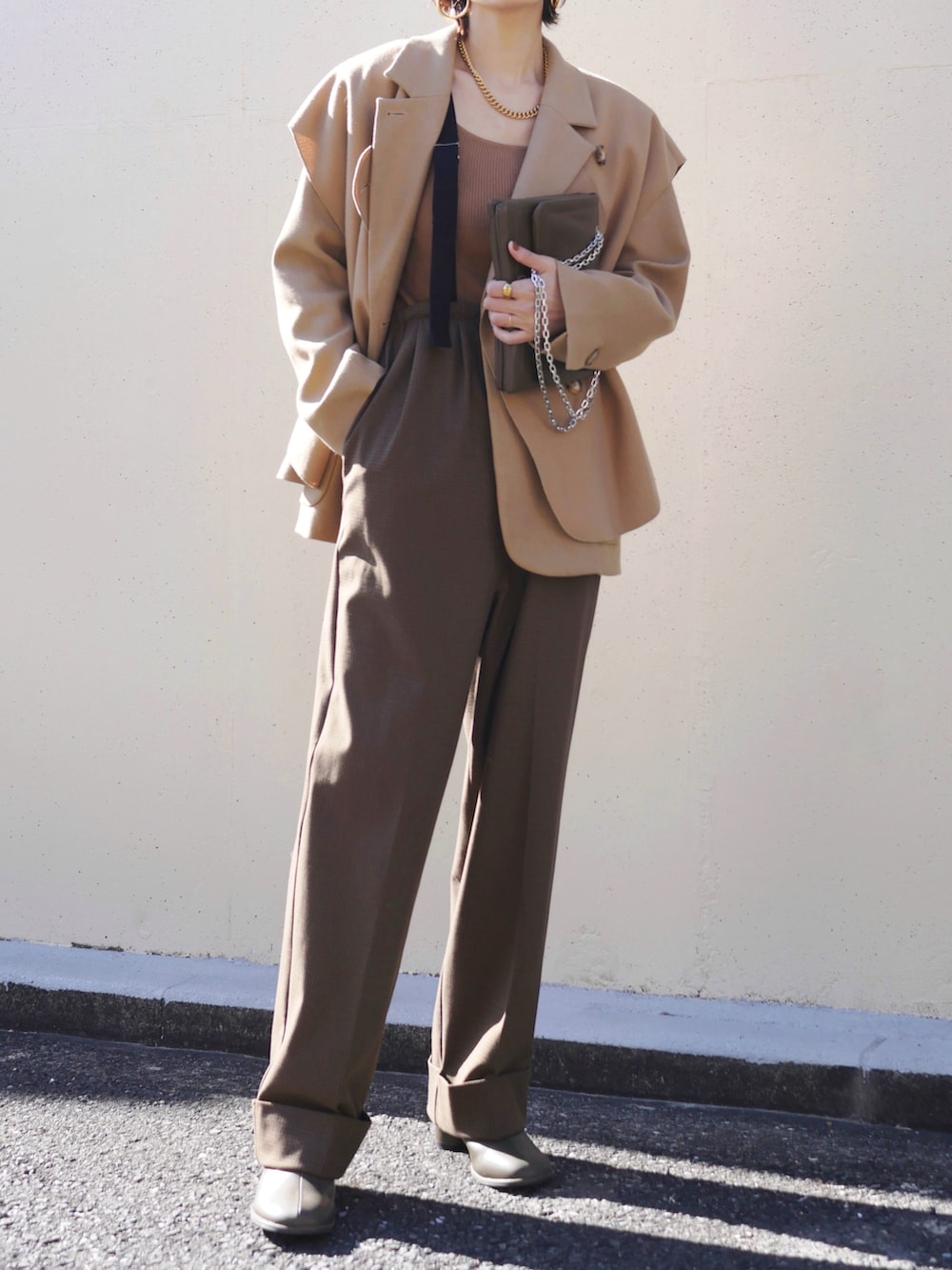 ブラウン系のその他パンツ、ブラウン系のショルダーバッグ、グリーン系のブーツを着用したレディースの冬コーディネートの2枚目の写真