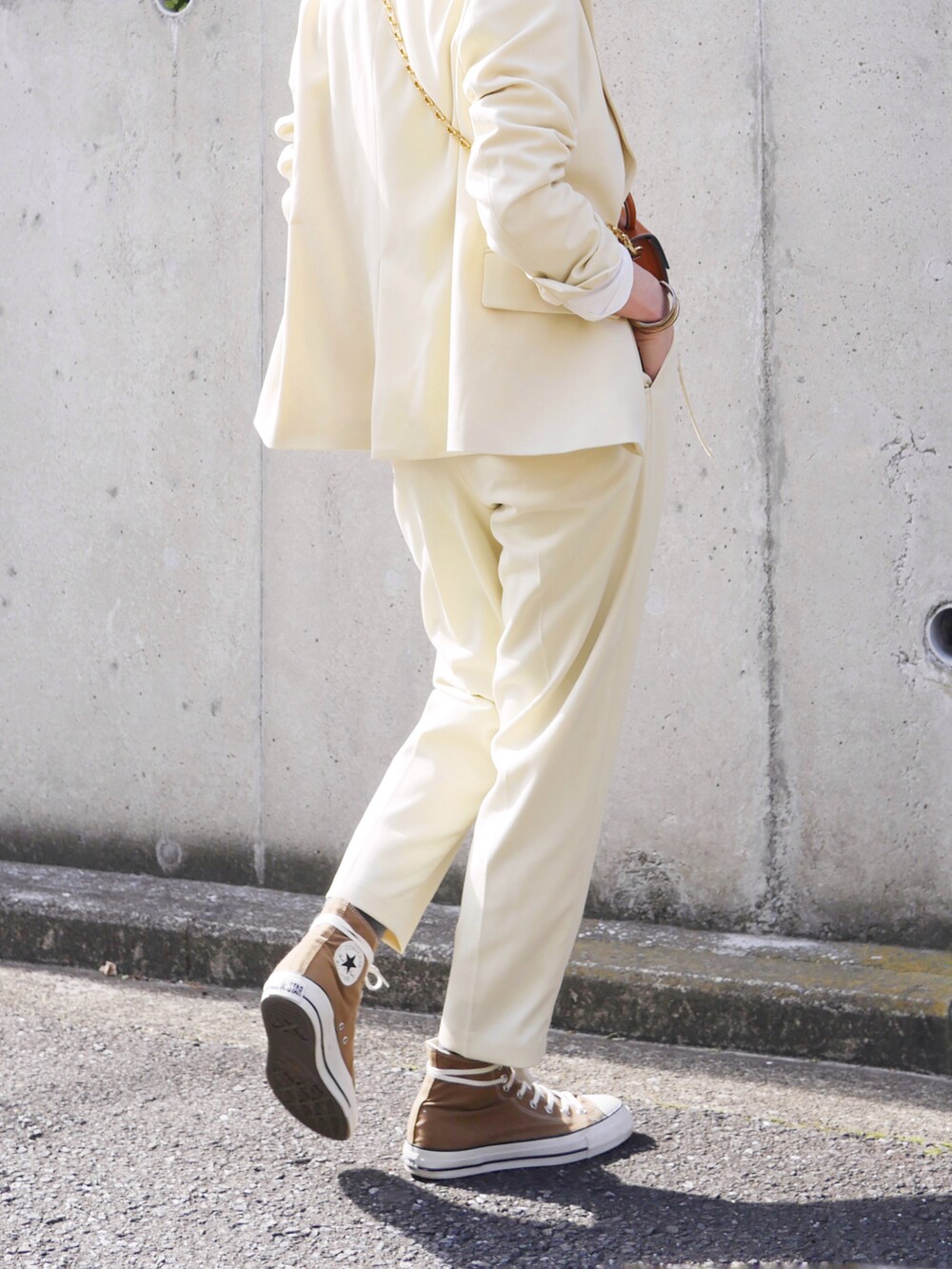 イエロー系のテーラードジャケット、イエロー系のその他パンツ、ホワイト系のTシャツ/カットソーを着用したレディースの冬コーディネートの4枚目の写真