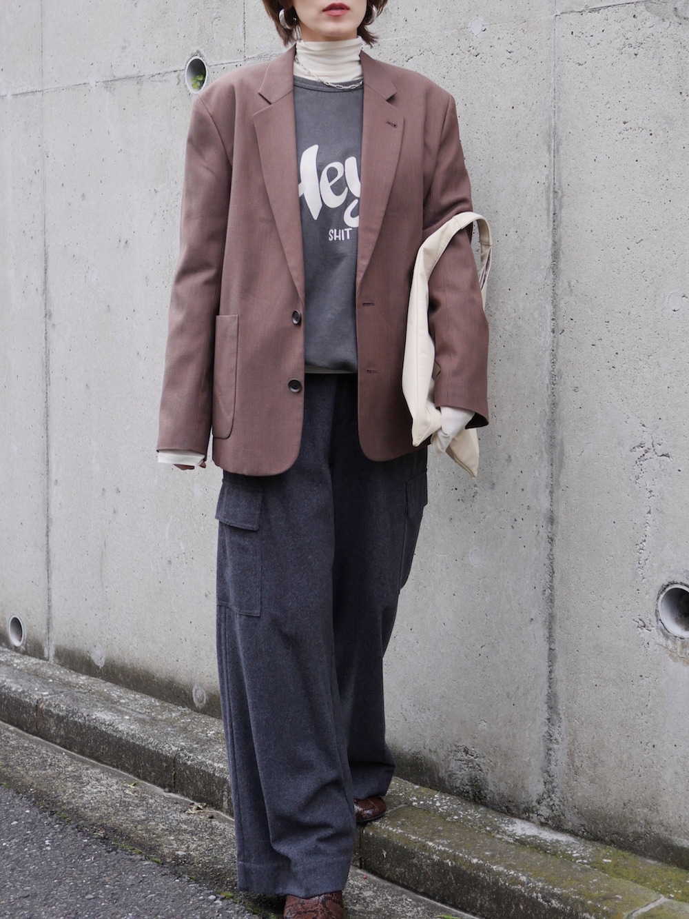 ブラウン系のテーラードジャケット、ホワイト系のTシャツ/カットソー、グレー系のカーゴパンツを着用したレディースの冬コーディネートの2枚目の写真