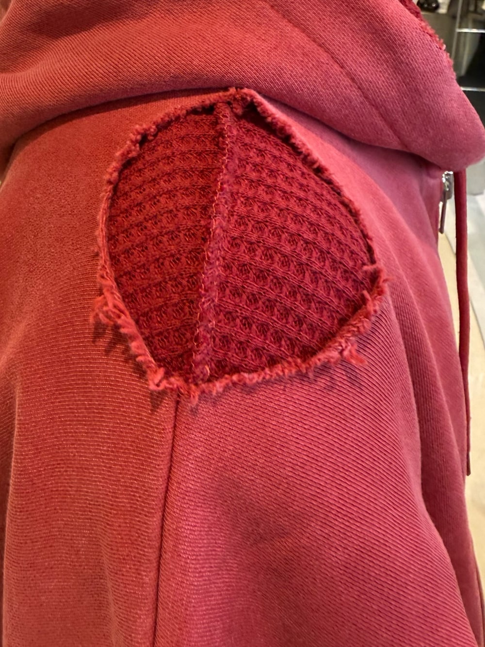 レッド系のパーカーを着用したメンズの冬コーディネートの6枚目の写真