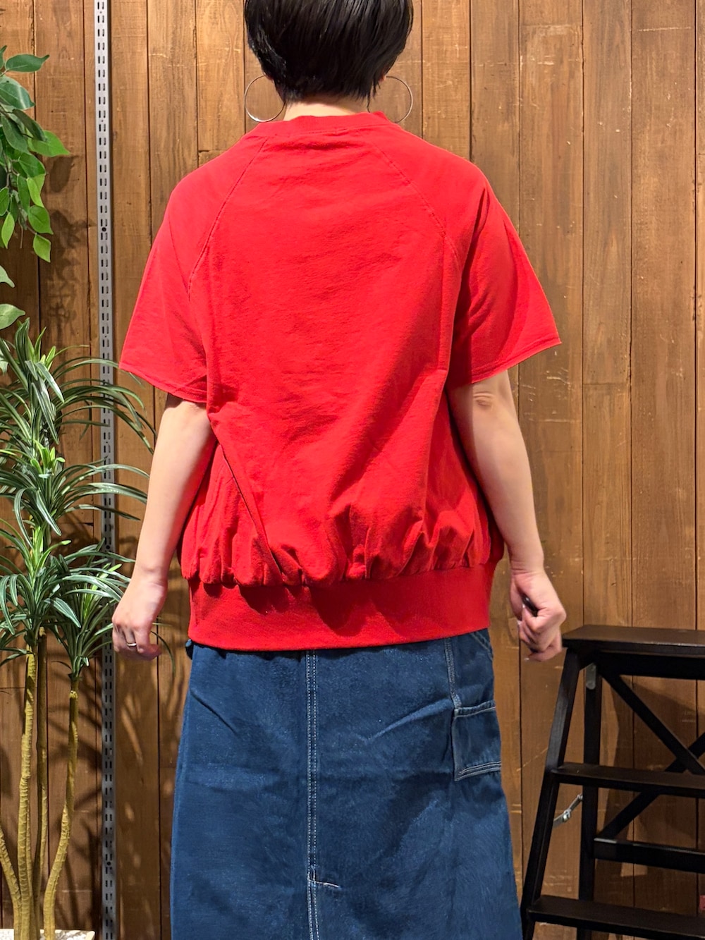 レッド系のTシャツ/カットソー、ブルー系のスカート、ブラック系のトートバッグを着用したレディースの夏コーディネートの6枚目の写真