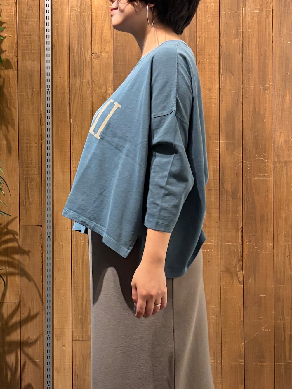 ブルー系のTシャツ/カットソー、ブラウン系のスカート、ブルー系のブルゾンを着用したレディースの秋コーディネートの10枚目の写真