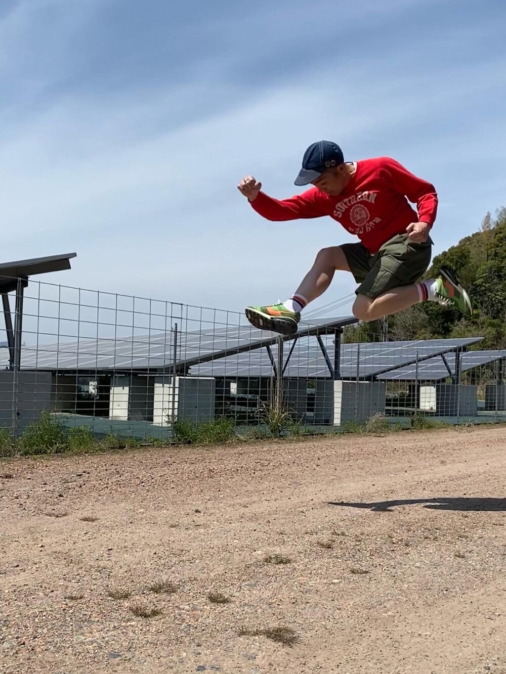 レッド系のスウェット、ピンク系のTシャツ/カットソー、グリーン系のカーゴパンツを着用したメンズの春コーディネートの3枚目の写真