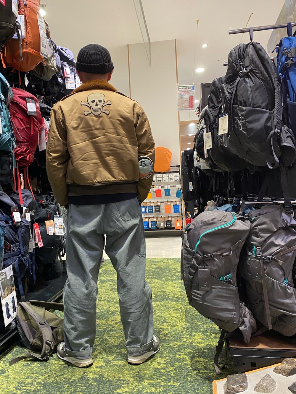 グリーン系のミリタリージャケット、ブラック系のスウェット、グレー系のデニムパンツを着用したメンズの冬コーディネートの2枚目の写真