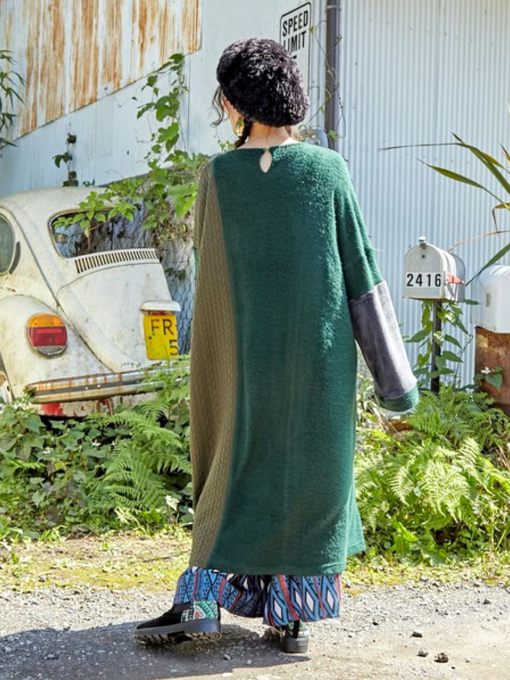 グリーン系のワンピース、ブルー系のその他パンツ、ブラック系のハンチング/ベレー帽を着用したレディースの秋コーディネートの3枚目の写真