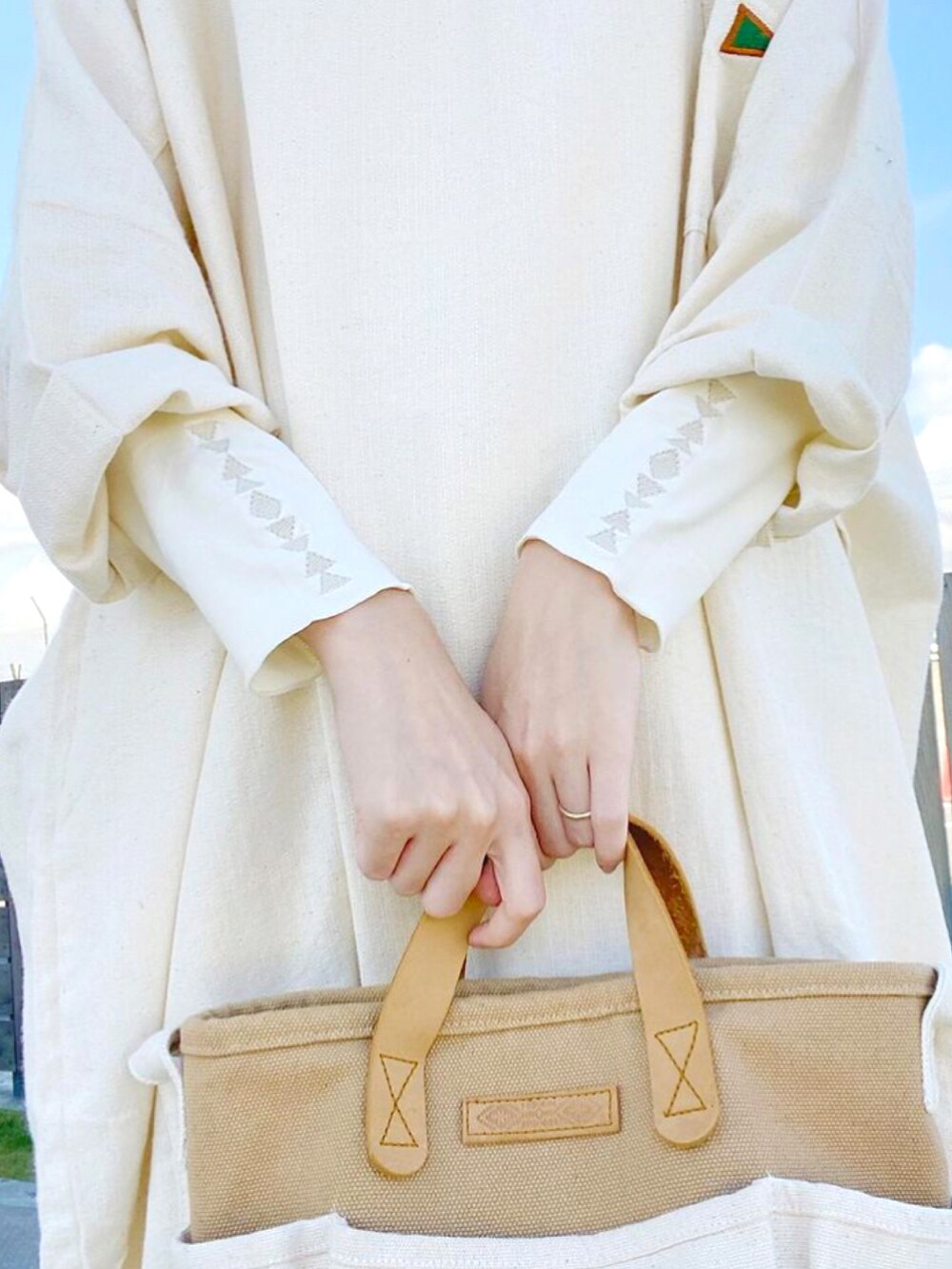 ホワイト系のワンピース、ベージュ系のショルダーバッグ、ホワイト系のTシャツ/カットソーを着用したレディースの冬コーディネートの3枚目の写真