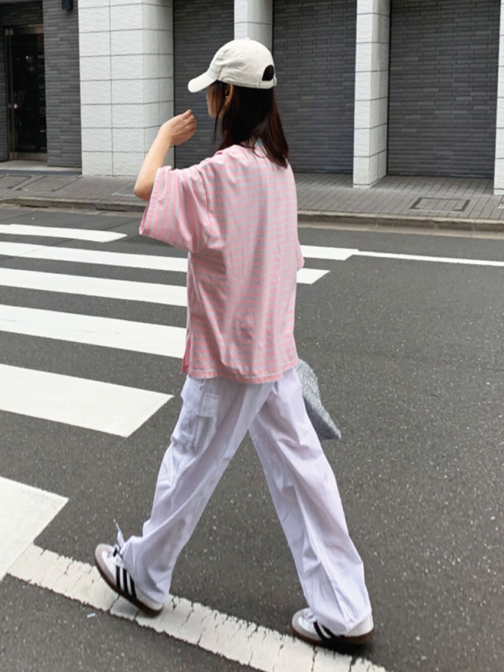 ホワイト系のカーゴパンツ、ホワイト系のスニーカー、シルバー系のトートバッグを着用したレディースの春コーディネートの2枚目の写真