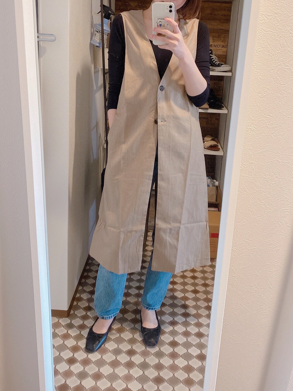 ブルー系のシャツ/ブラウス、ベージュ系のベスト、ブラック系のバレエシューズを着用したレディースの春コーディネートの3枚目の写真