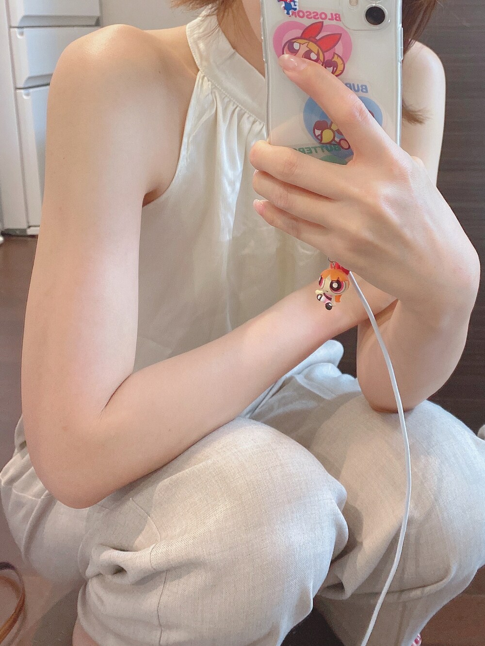 ベージュ系のパンツ、ホワイト系のトップスを着用したレディースの夏コーディネートの2枚目の写真