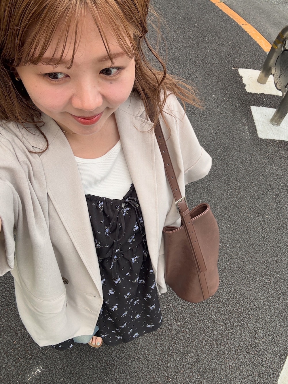 ブルー系のデニムパンツ、ホワイト系のタンクトップ、ブラック系のチュニックを着用したレディースの春コーディネートの4枚目の写真