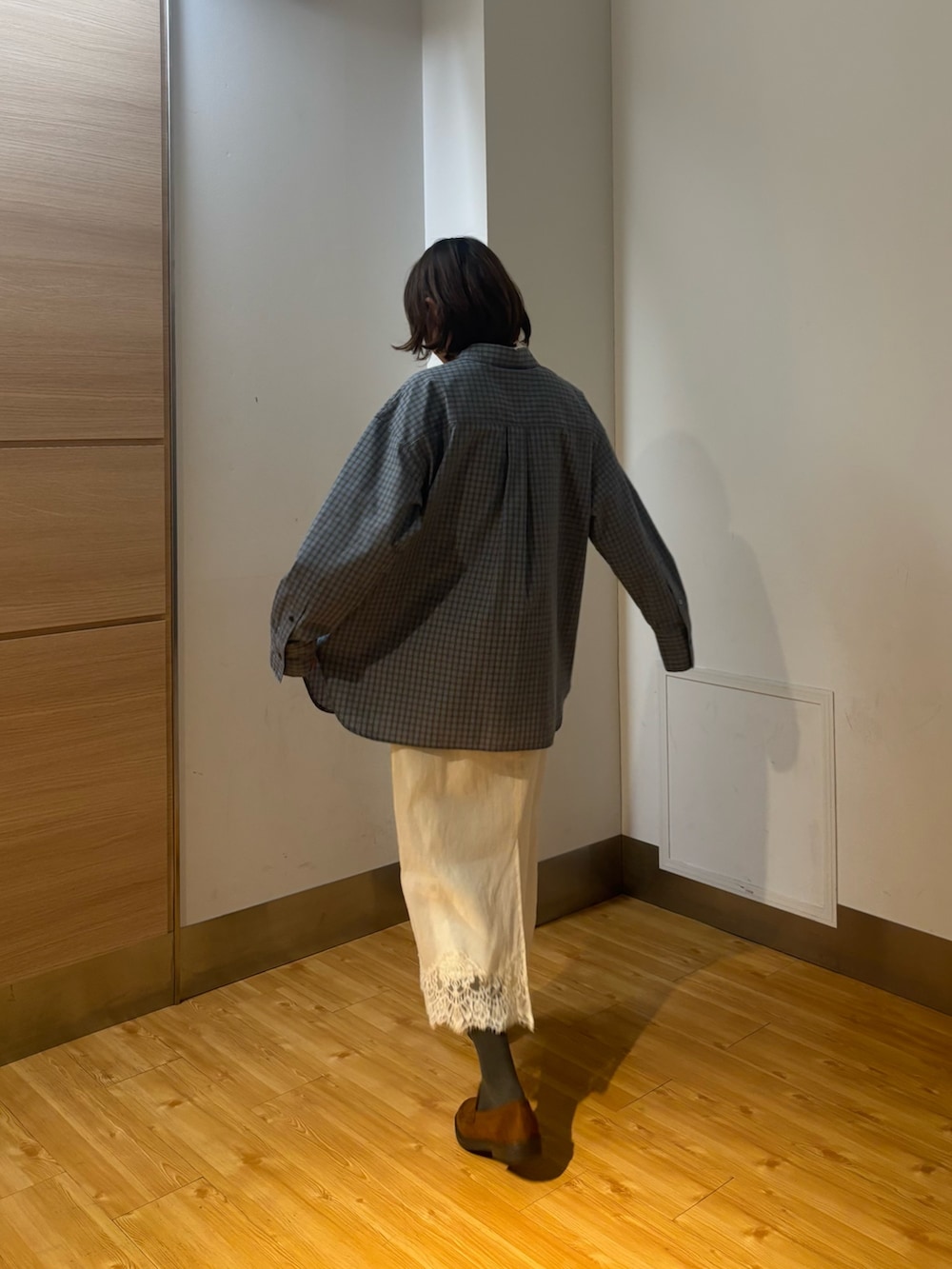 ホワイト系のスカート、ブルー系のシャツ/ブラウス、イエロー系のローファーを着用したレディースの冬コーディネートの4枚目の写真