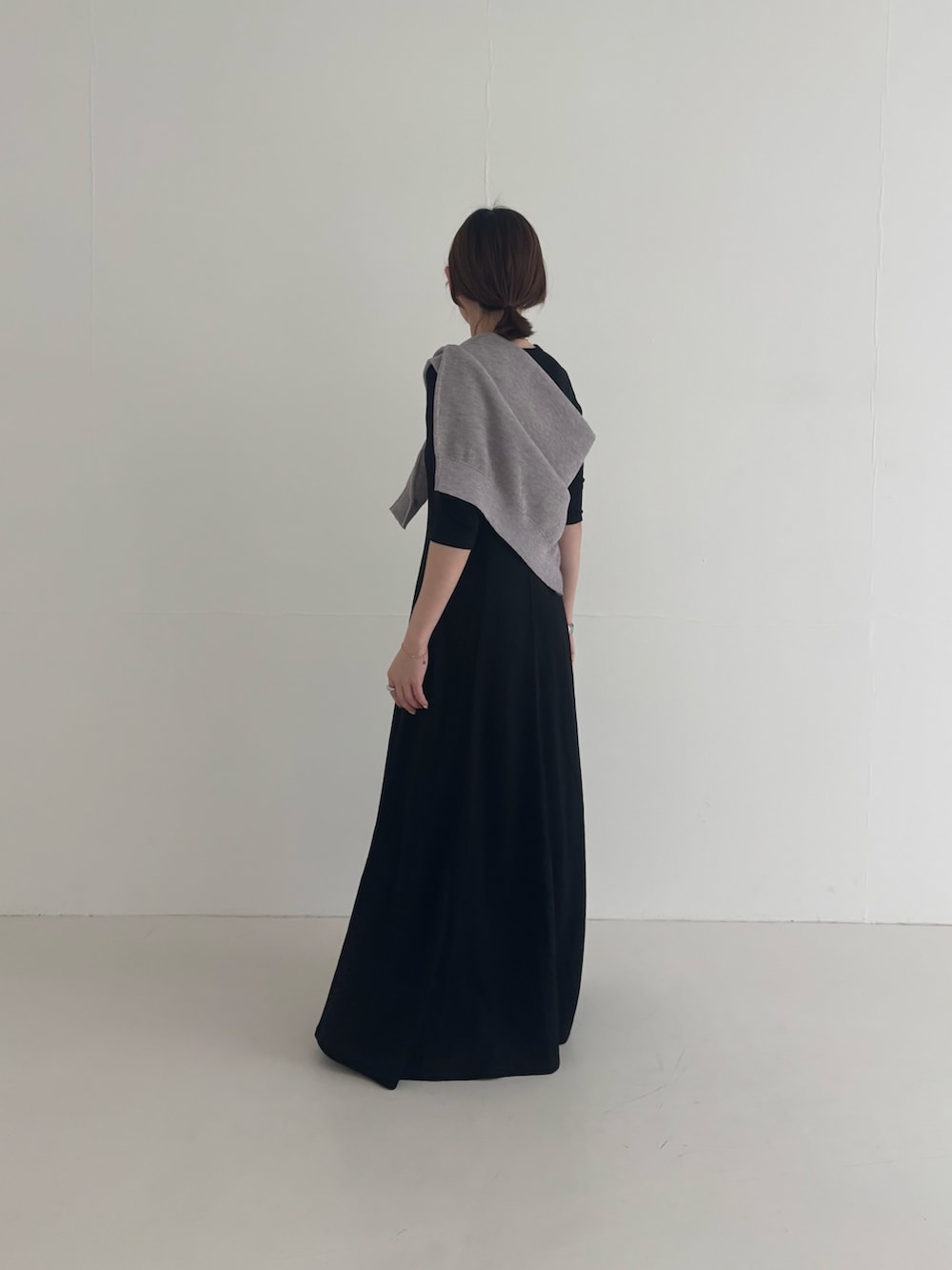 ブラック系のワンピース、ブラック系のその他アウター、グレー系のニット/セーターを着用したレディースの春コーディネートの5枚目の写真