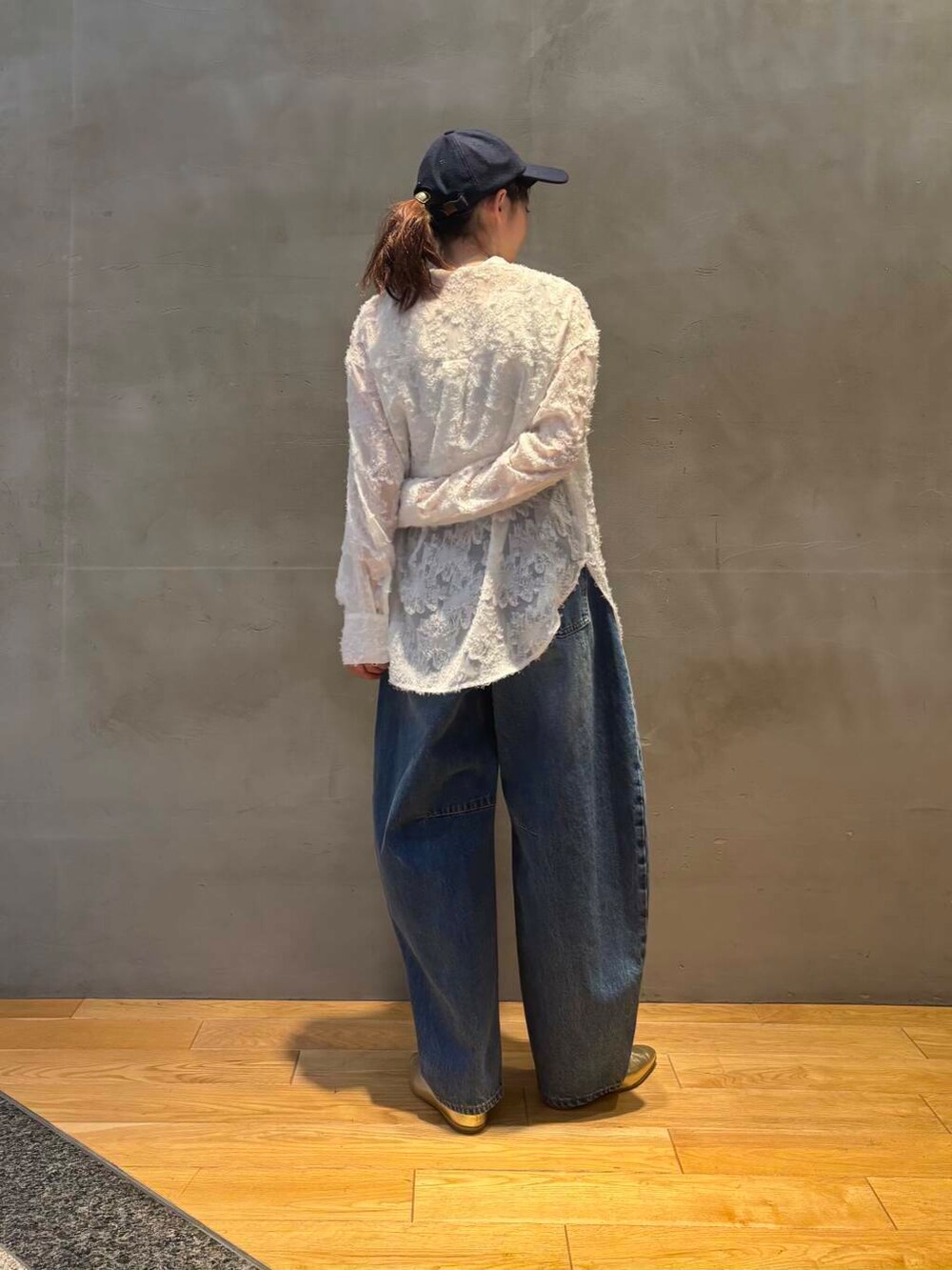 ブルー系のデニムパンツ、ホワイト系のシャツ/ブラウス、グレー系のトレンチコートを着用したレディースの冬コーディネートの6枚目の写真