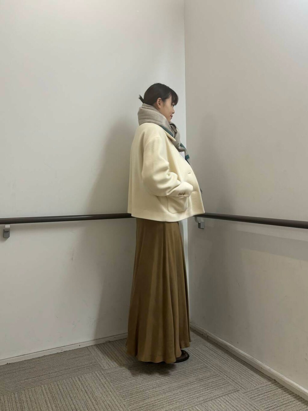 ホワイト系のその他アウター、イエロー系のスカート、ホワイト系のカーディガン/ボレロを着用したレディースの冬コーディネートの4枚目の写真