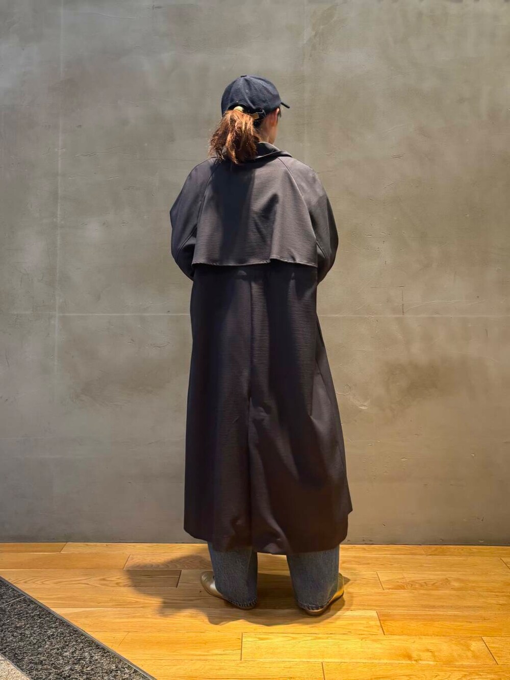 ブルー系のデニムパンツ、ホワイト系のシャツ/ブラウス、グレー系のトレンチコートを着用したレディースの冬コーディネートの4枚目の写真