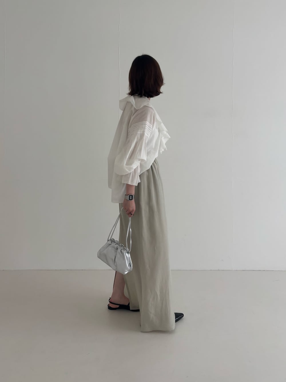 ブルー系のその他アウター、ベージュ系のスカート、ブラック系のパンプスを着用したレディースの春コーディネートの6枚目の写真