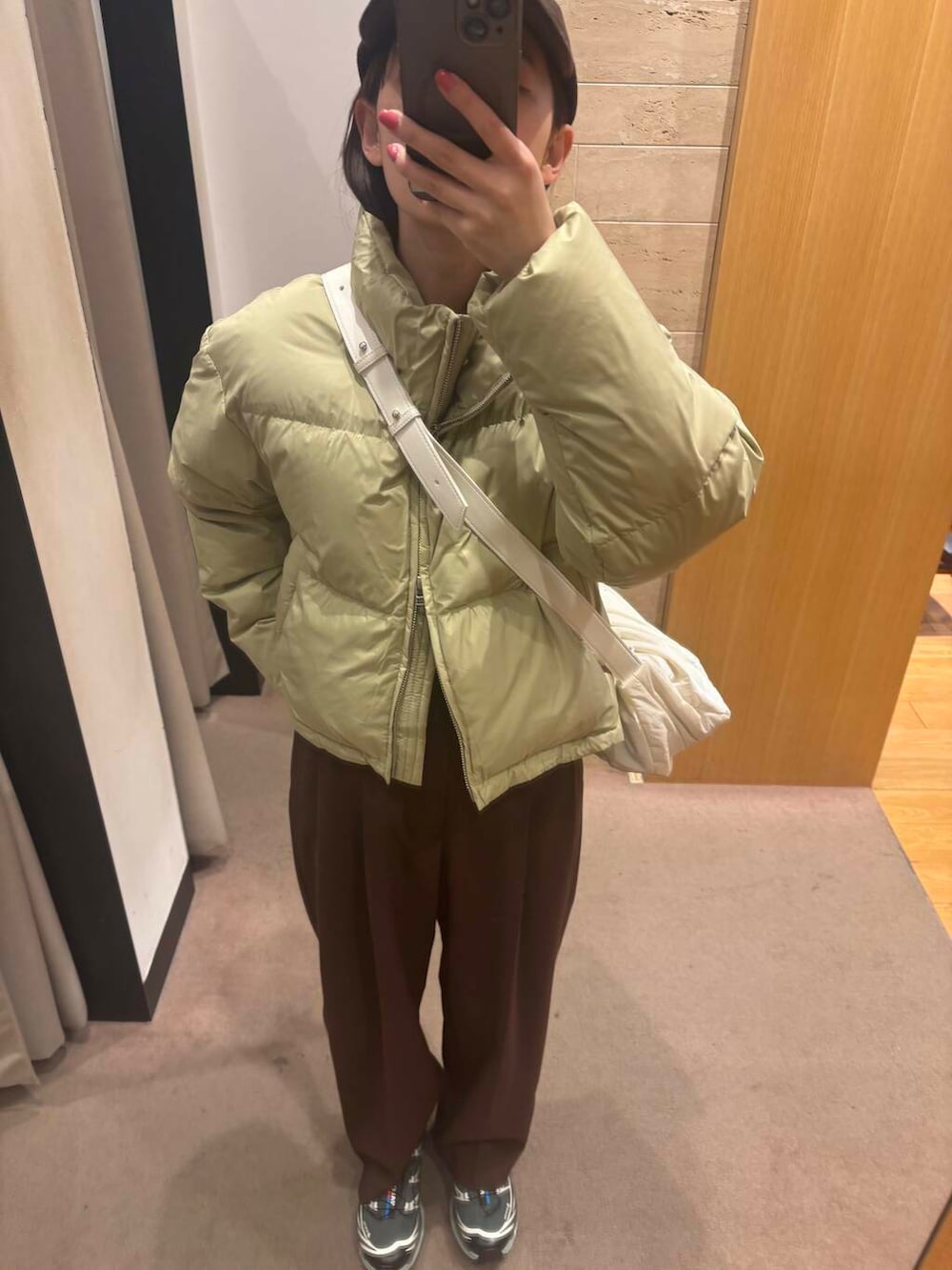 ブラウン系のニット/セーター、ブラウン系のその他パンツ、ベージュ系のダウンジャケット/コートを着用したレディースの冬コーディネートの3枚目の写真