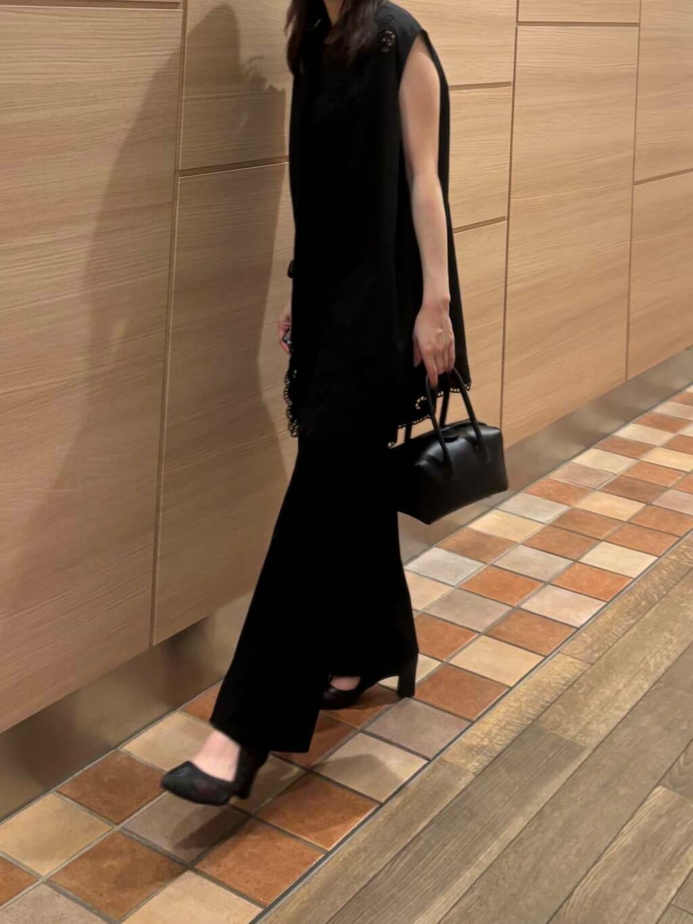 ブラック系のTシャツ/カットソー、ブラック系のパンプス、ブラック系のハンドバッグを着用したレディースの夏コーディネートの3枚目の写真