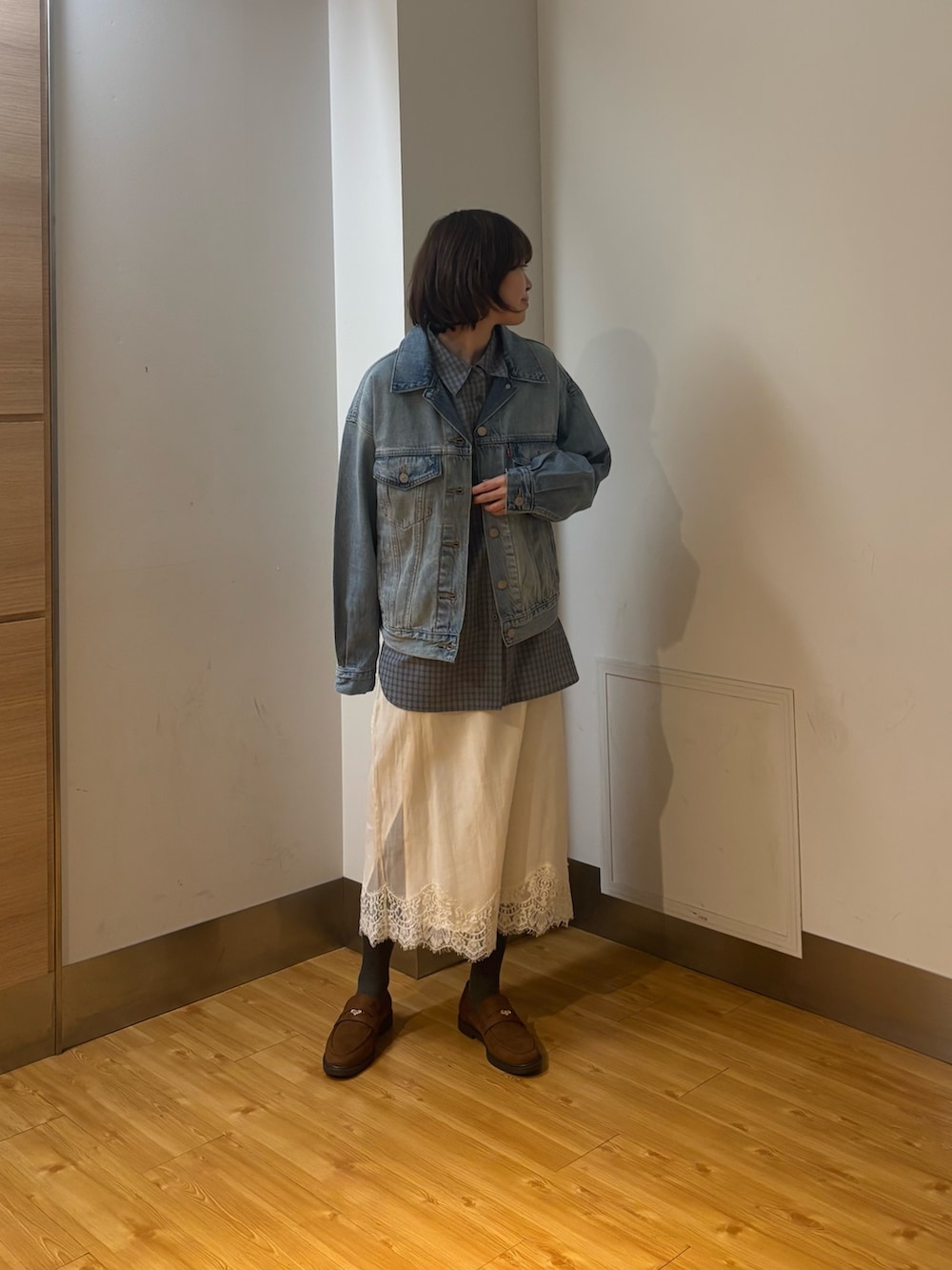 ホワイト系のスカート、ブルー系のシャツ/ブラウス、イエロー系のローファーを着用したレディースの冬コーディネートの3枚目の写真