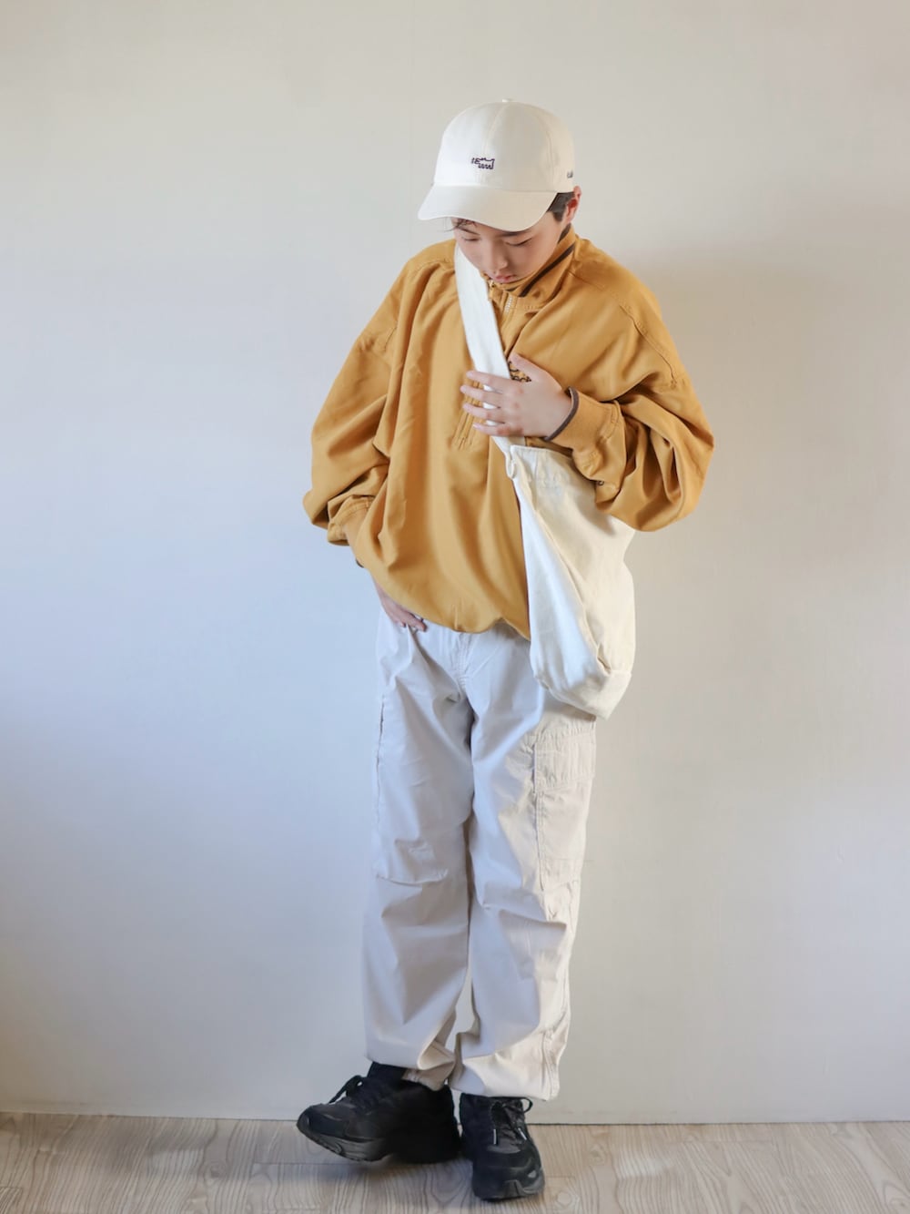 イエロー系のスウェット、ブラック系のカーゴパンツ、ブラック系のスニーカーを着用したキッズの春コーディネートの2枚目の写真