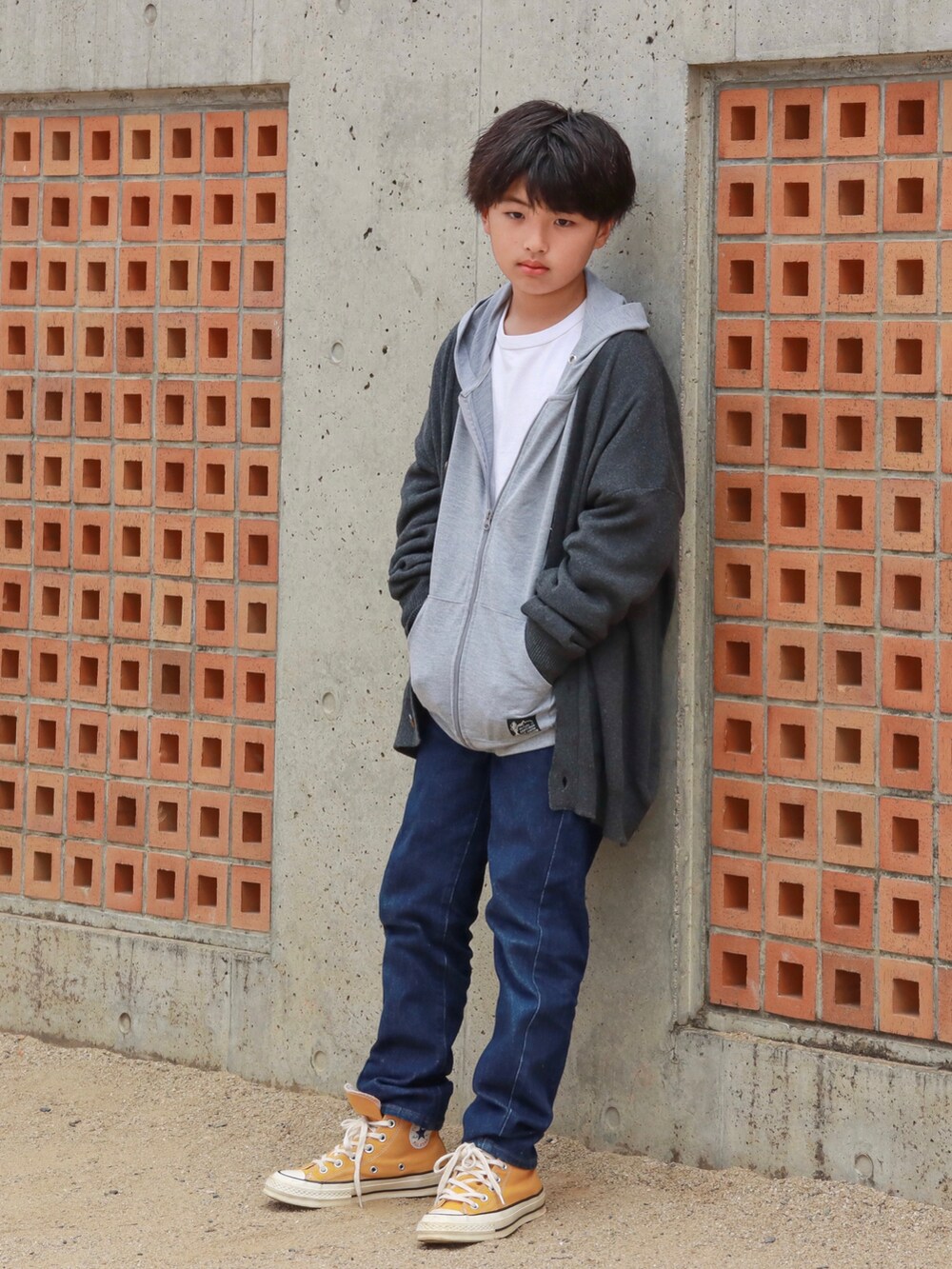 グレー系のカーディガン/ボレロ、ブルー系のデニムパンツ、イエロー系のスニーカーを着用したキッズの秋コーディネートの4枚目の写真