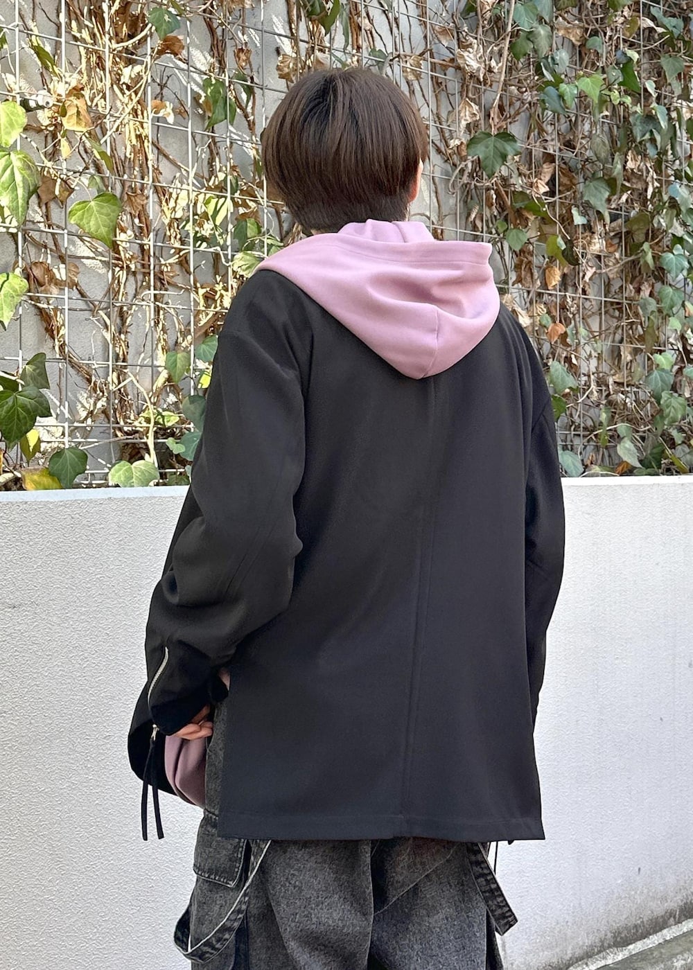 パープル系のパーカー、グレー系のカーゴパンツ、ブラック系のテーラードジャケットを着用したメンズの冬コーディネートの8枚目の写真