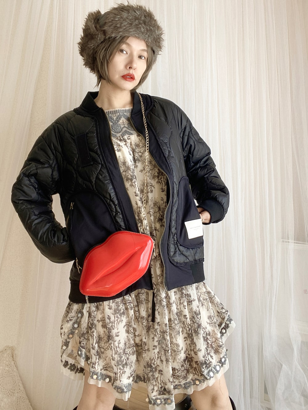 ブラック系のジャケット/アウター、ブラック系のシューズ、ホワイト系のワンピース/ドレスを着用したレディースの冬コーディネートの3枚目の写真