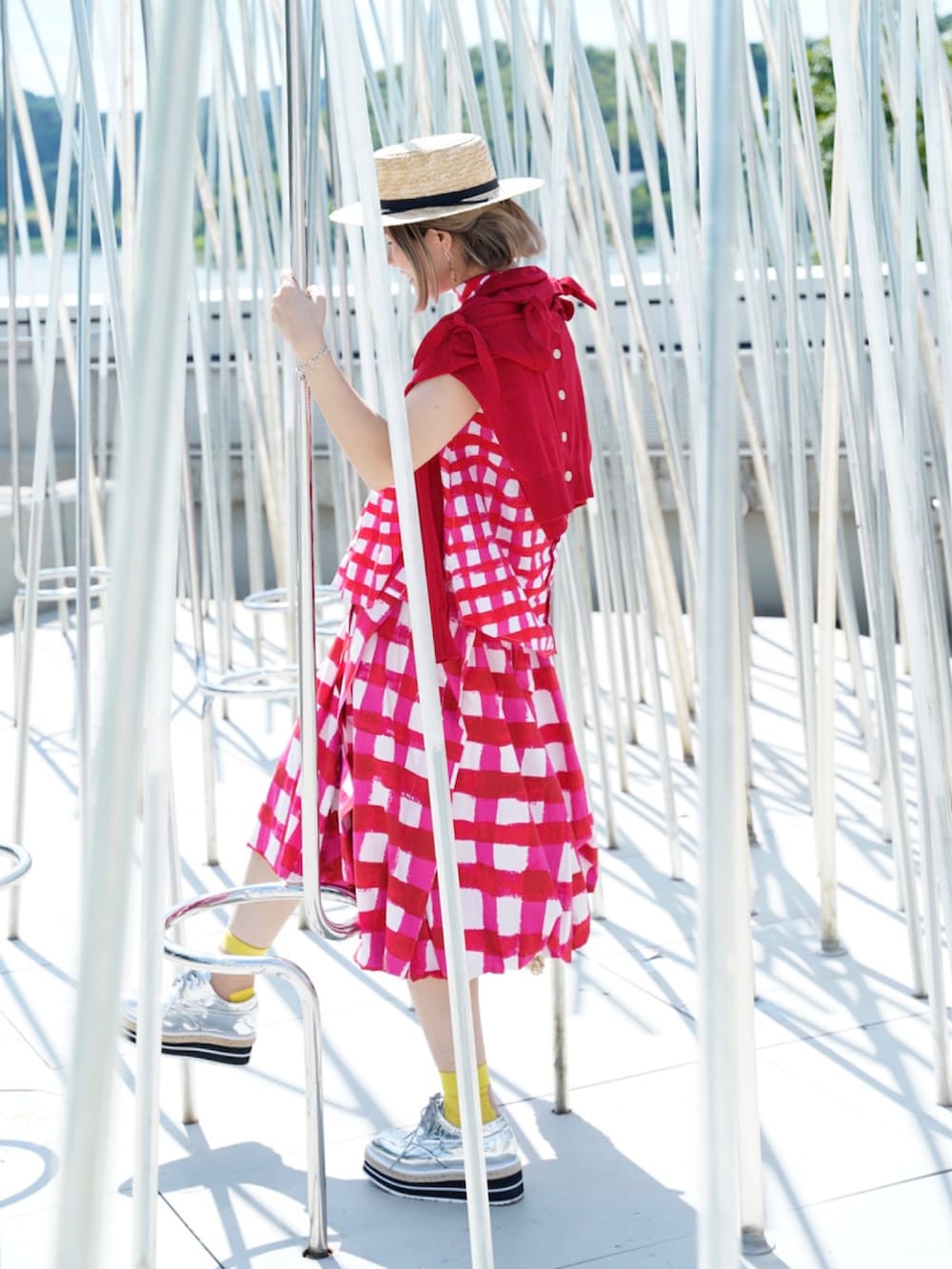 レッド系のカーディガン/ボレロ、ピンク系のトップス、シルバー系のシューズを着用したレディースの春コーディネートの3枚目の写真