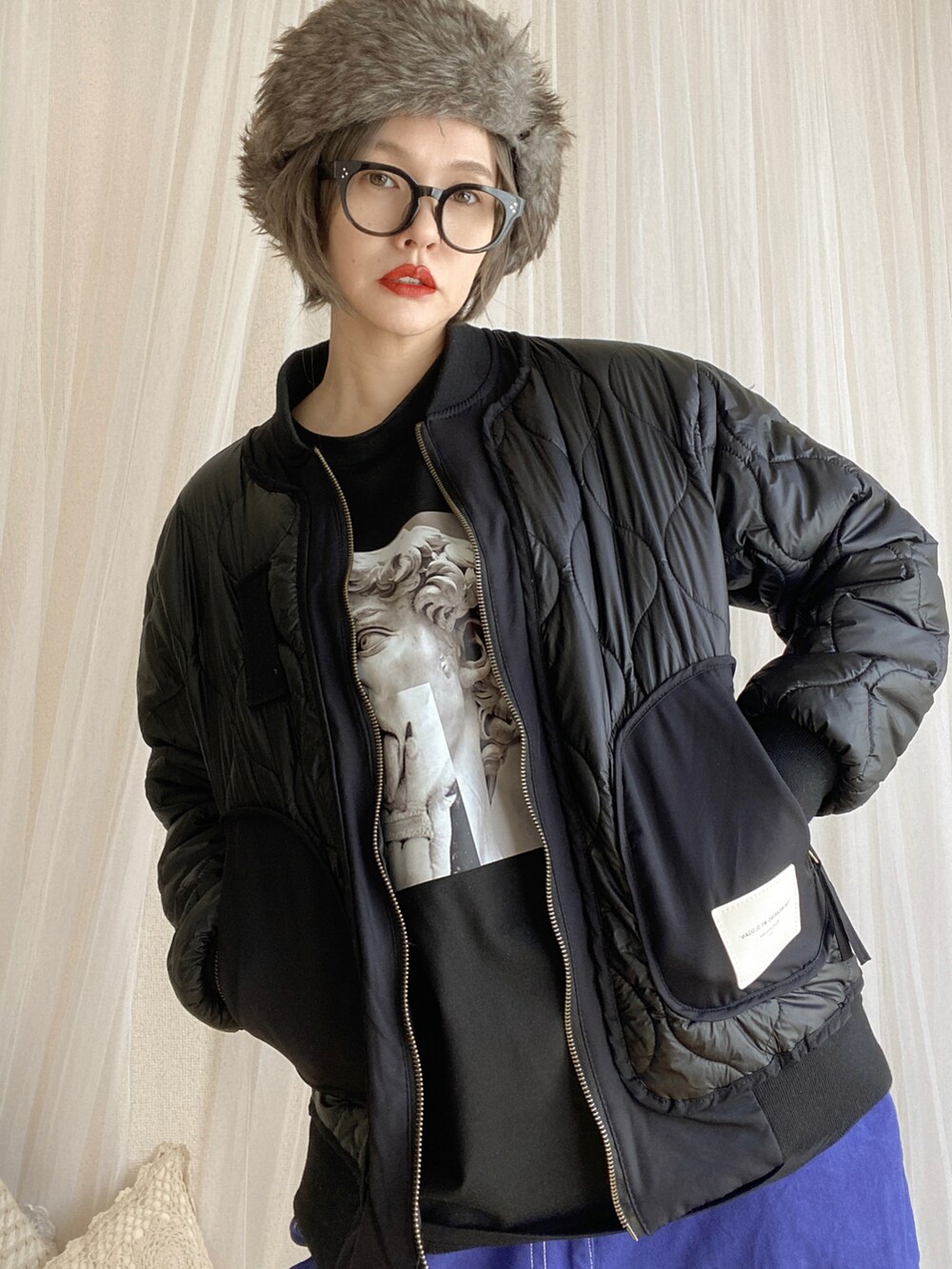 ブラック系のスニーカー、ブルー系のパンツ、ブラック系のジャケット/アウターを着用したレディースの冬コーディネートの4枚目の写真