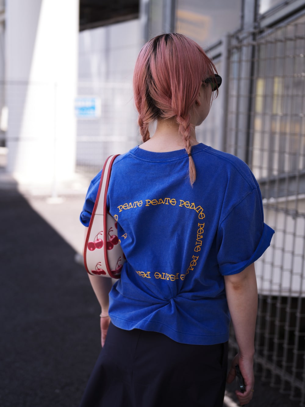 ブルー系のTシャツ/カットソー、レッド系のショルダーバッグ、ブルー系のスカートを着用したレディースの夏コーディネートの2枚目の写真