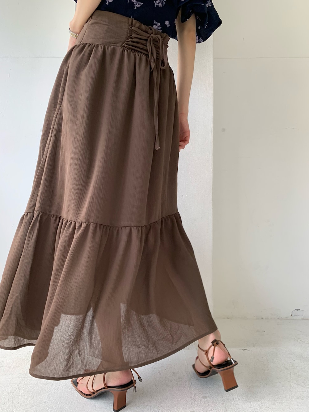ブラウン系のスカート、ブルー系のシャツ/ブラウス、ブラウン系のサンダルを着用したレディースの春コーディネートの4枚目の写真
