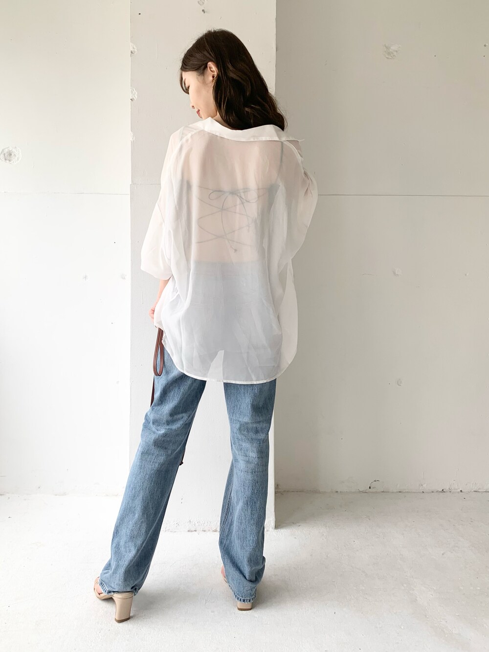 ホワイト系のシャツ/ブラウス、ブラック系のキャミソール、ブルー系のデニムパンツを着用したレディースの夏コーディネートの3枚目の写真