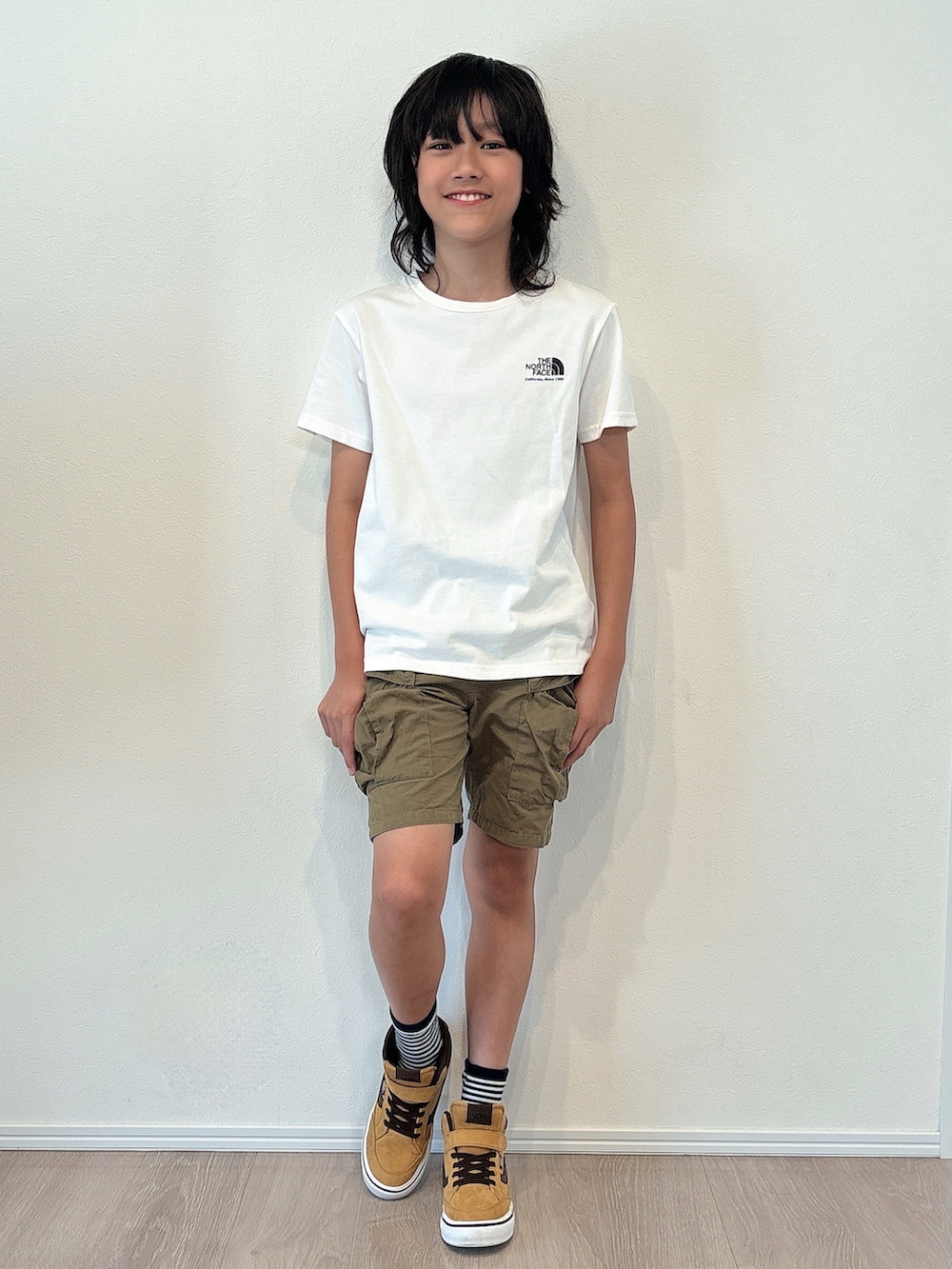 ホワイト系のTシャツ/カットソー、グリーン系のその他パンツ、ブラウン系のスニーカーを着用したキッズの秋コーディネートの4枚目の写真