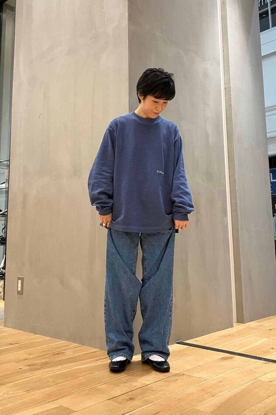 ブラック系のバレエシューズ、ブルー系のデニムパンツ、ブラック系のショルダーバッグを着用したレディースの夏コーディネートの5枚目の写真