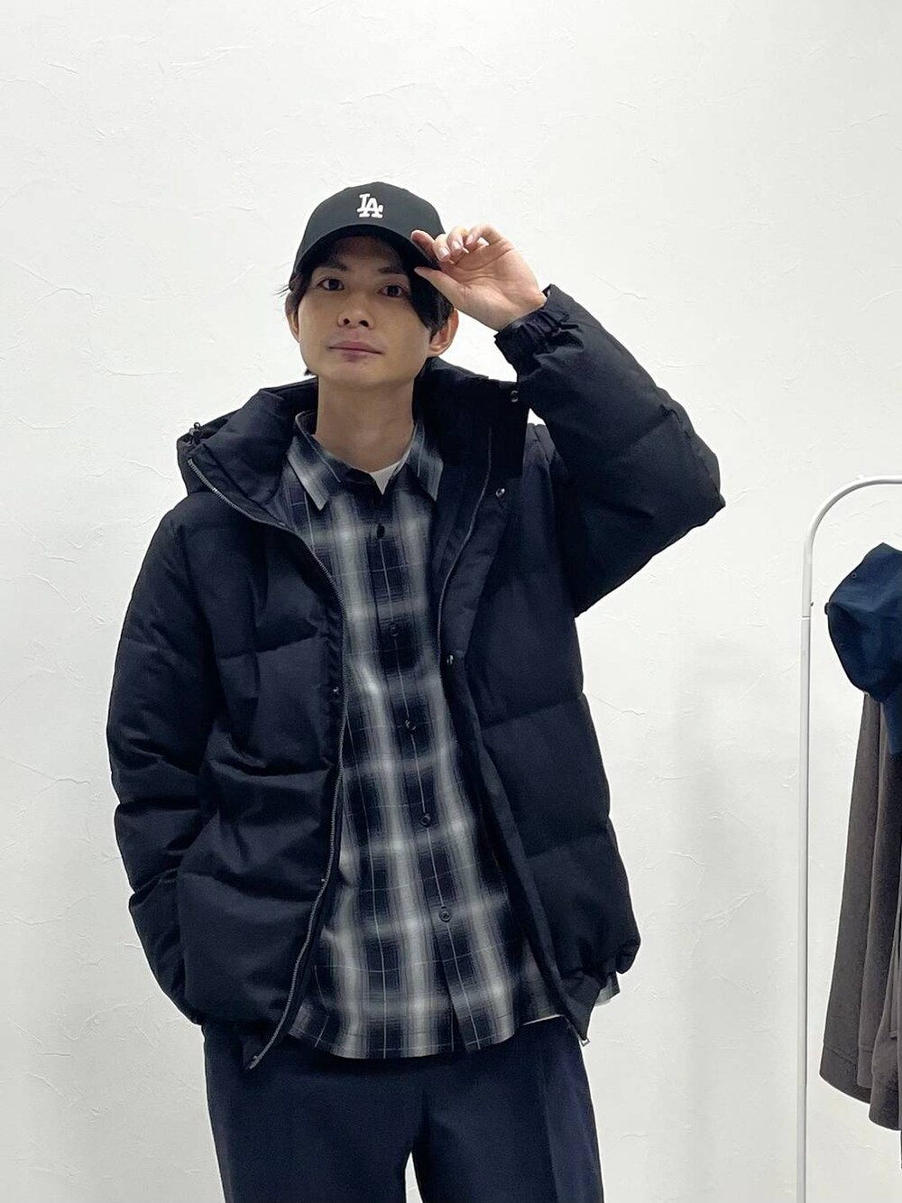 ブラック系のダウンジャケット/コート、ブルー系のデニムパンツ、ブラック系のシャツ/ブラウスを着用したメンズの冬コーディネートの2枚目の写真