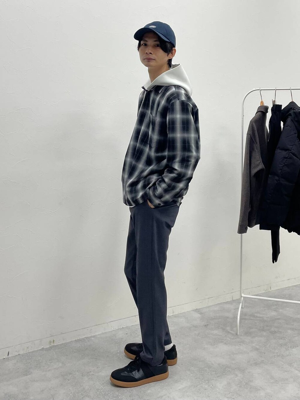 ホワイト系のパーカー、ブラック系のスニーカー、グレー系のスウェットパンツを着用したメンズの冬コーディネートの2枚目の写真