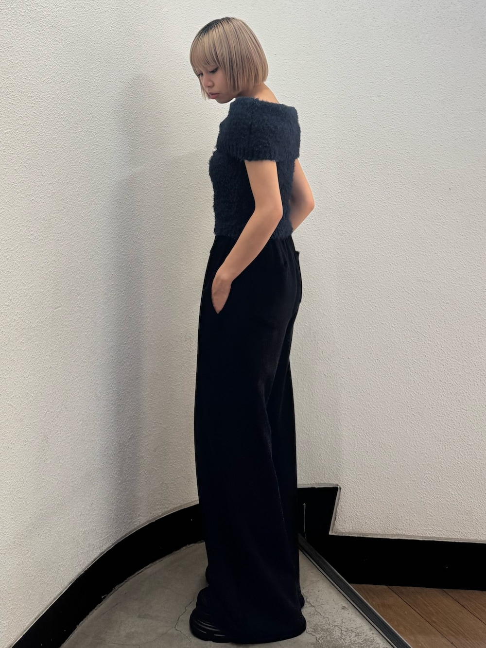 ブルー系のニット/セーター、ブラック系のスウェットパンツ、ブラック系のローファーを着用したレディースの秋コーディネートの2枚目の写真