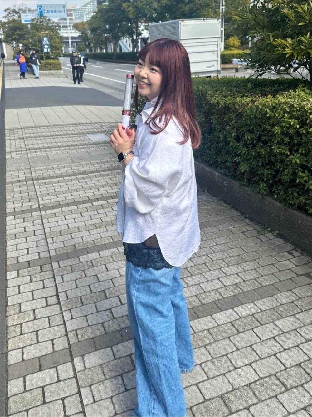 ブルー系のデニムパンツ、ブルー系のトートバッグ、ブラウン系のキャミソールを着用したレディースの春コーディネートの3枚目の写真