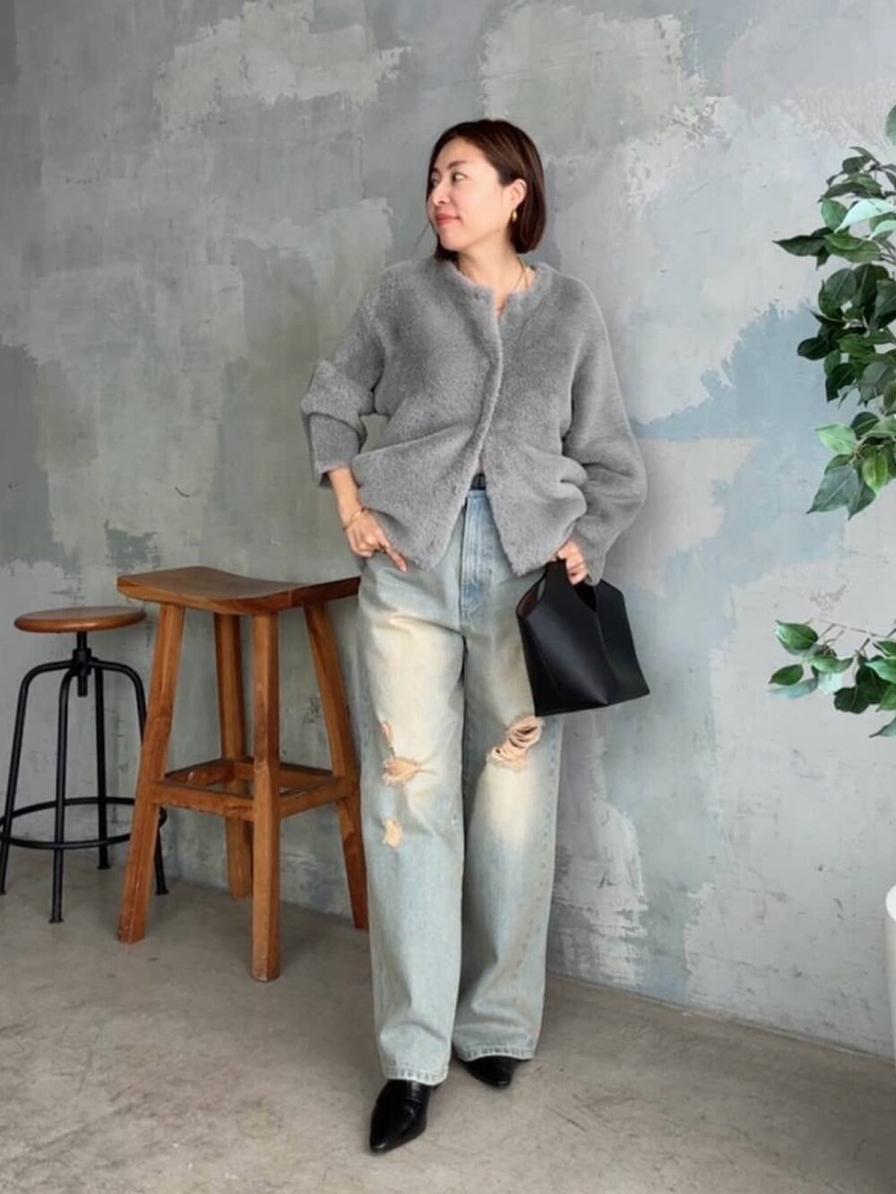 グレー系のカーディガン/ボレロ、ブルー系のデニムパンツ、ブラック系のローファーを着用したレディースの秋コーディネートの3枚目の写真