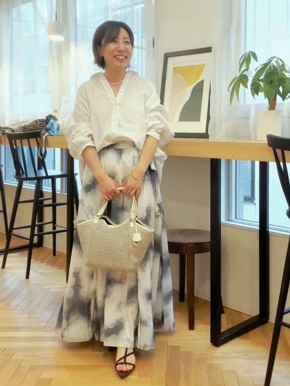 ホワイト系のシャツ/ブラウス、ブラック系のサンダル、ホワイト系のハンドバッグを着用したレディースの春コーディネートの2枚目の写真