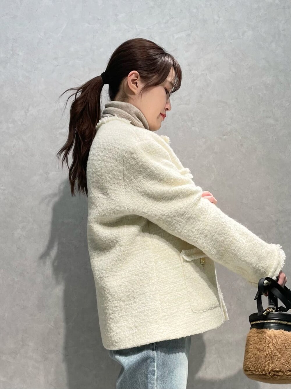 ホワイト系のその他アウター、ブルー系のデニムパンツ、ブラウン系のローファーを着用したレディースの冬コーディネートの3枚目の写真