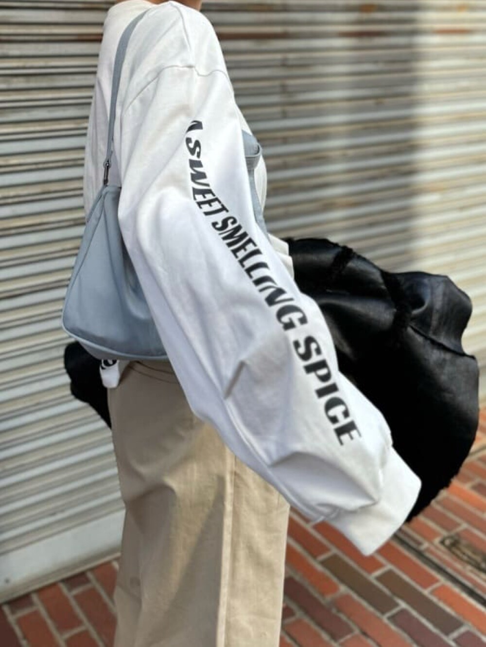 ホワイト系のTシャツ/カットソー、ベージュ系のチノパンツを着用したレディースの冬コーディネートの2枚目の写真