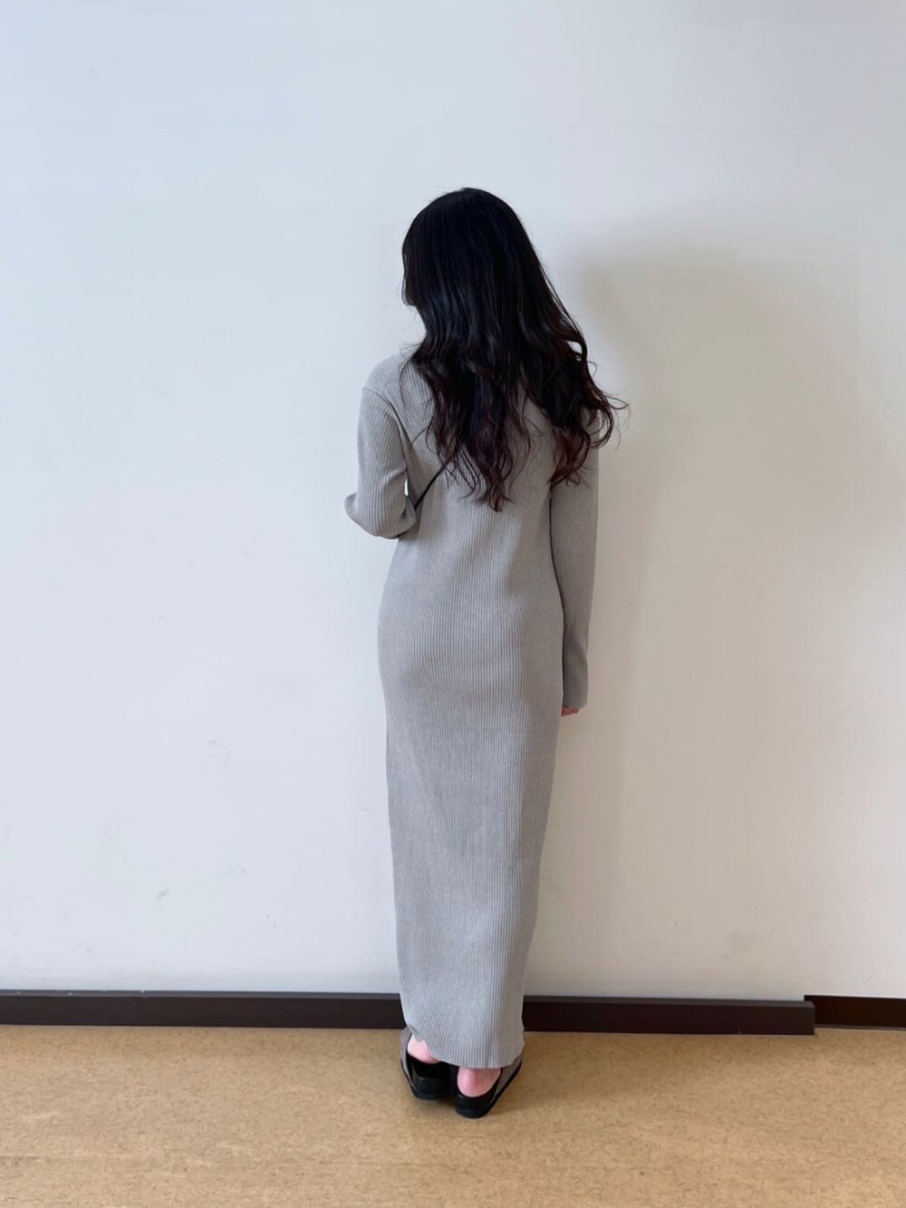 ブラック系のマウンテンパーカー、グレー系のワンピース、ブラック系のショルダーバッグを着用したレディースの春コーディネートの5枚目の写真