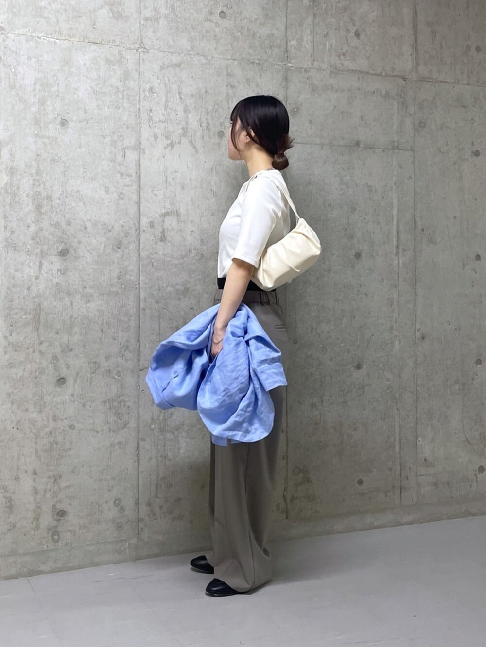 ホワイト系のTシャツ/カットソー、グレー系のスラックスを着用したレディースの春コーディネートの2枚目の写真