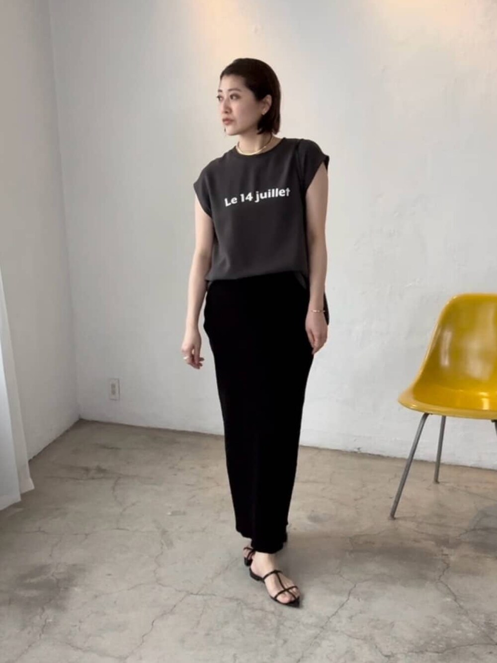 グレー系のシャツ/ブラウス、ブラック系のスカート、ブラック系のサンダルを着用したレディースの夏コーディネートの2枚目の写真