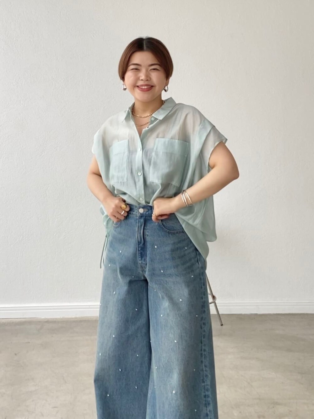 ブルー系のデニムパンツ、グリーン系のシャツ/ブラウスを着用したレディースの春コーディネートの5枚目の写真