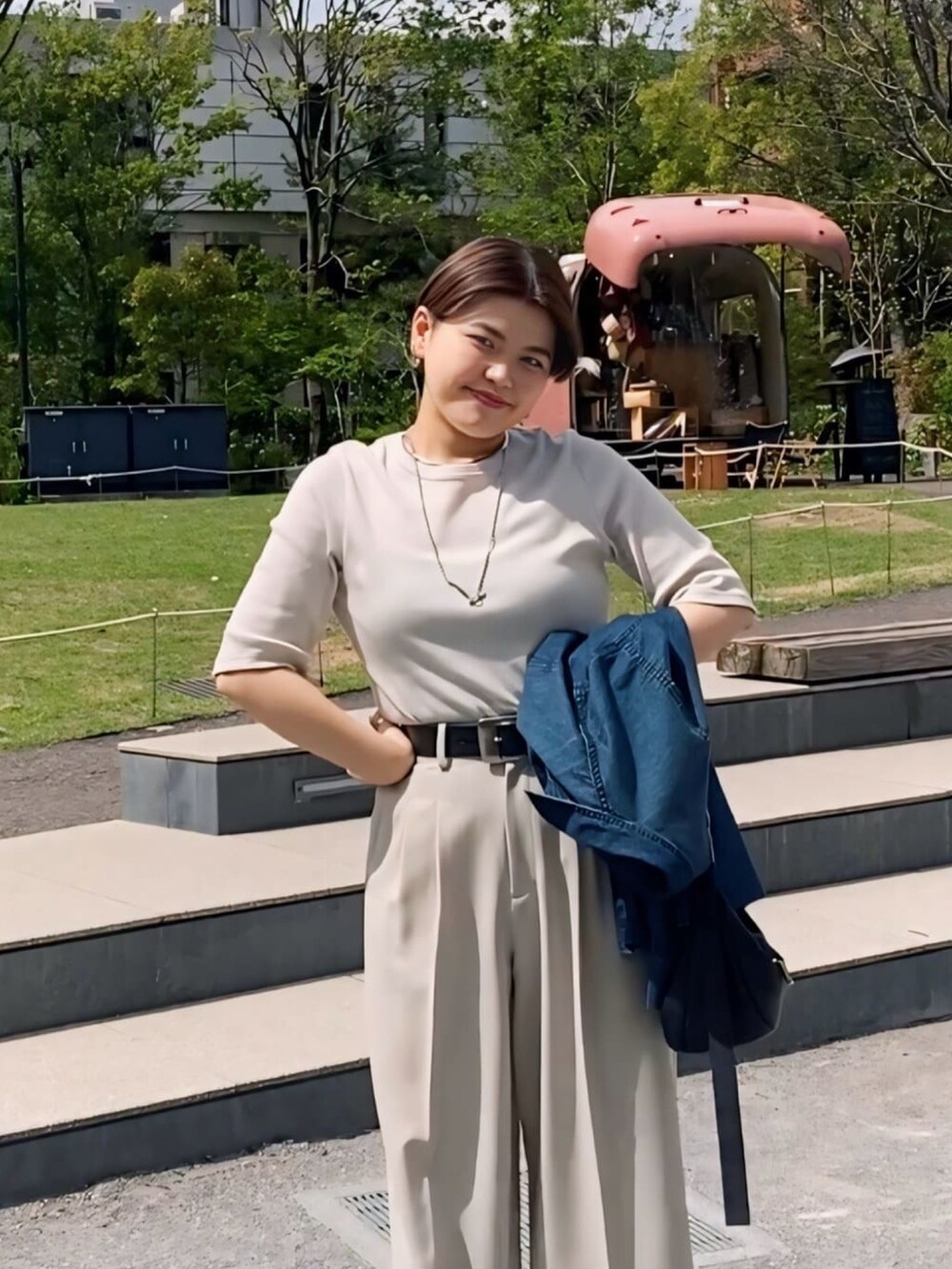 グレー系のTシャツ/カットソー、ブルー系のスラックス、シルバー系のサンダルを着用したレディースの春コーディネートの2枚目の写真