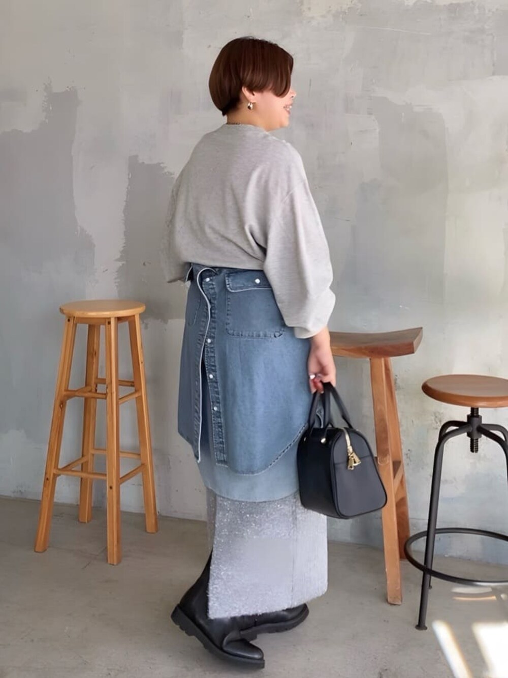グレー系のスウェット、グレー系のスカート、ブルー系のシャツ/ブラウスを着用したレディースの秋コーディネートの2枚目の写真