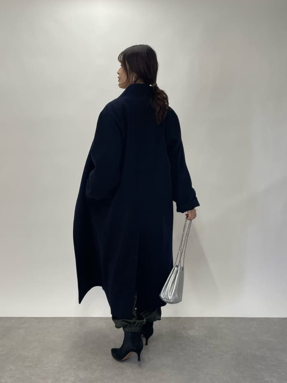 グリーン系のカーゴパンツ、ホワイト系のシャツ/ブラウス、ブラック系のブーツを着用したレディースの冬コーディネートの3枚目の写真