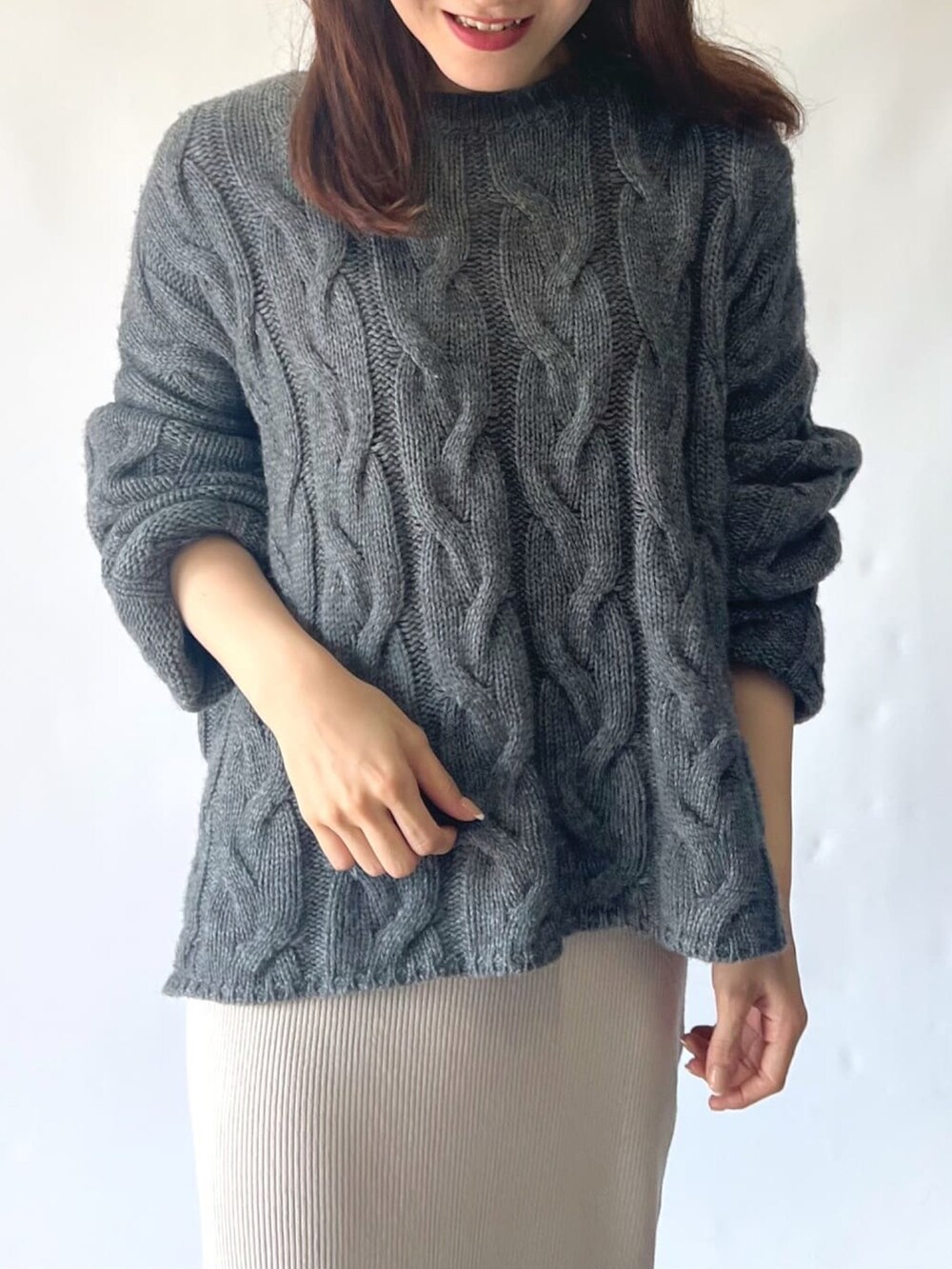 ベージュ系のスカート、グレー系のニット/セーター、イエロー系のボストンバッグを着用したレディースの秋コーディネートの5枚目の写真